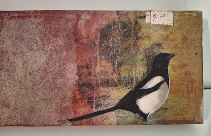 Collage „Elster“ von Monika Schiwy-Jessen, Querformat auf Box, handgefärbte Papiere und Stoffe, Naturmotiv, 10x24,5x2,5 cm.